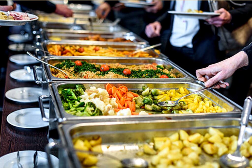 Guests being served from a professional catering buffet line