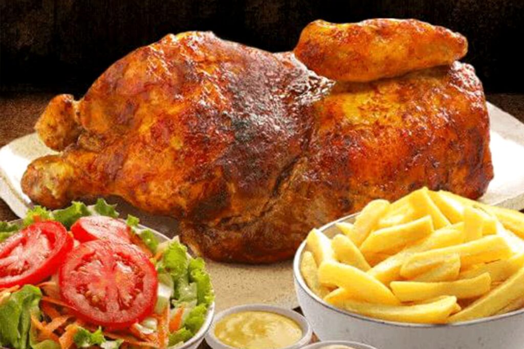 Whole roasted chicken served with fries and fresh salad